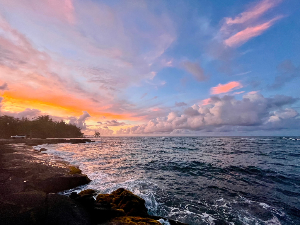 Hawaii sunset over ocean cliffs
