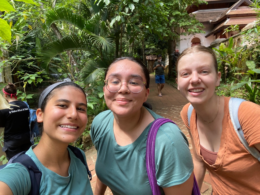 Three students group together, smiling Thailand, trip jungle track