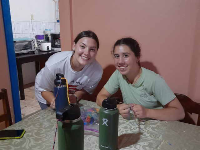 host family sisters sitting in kitchen