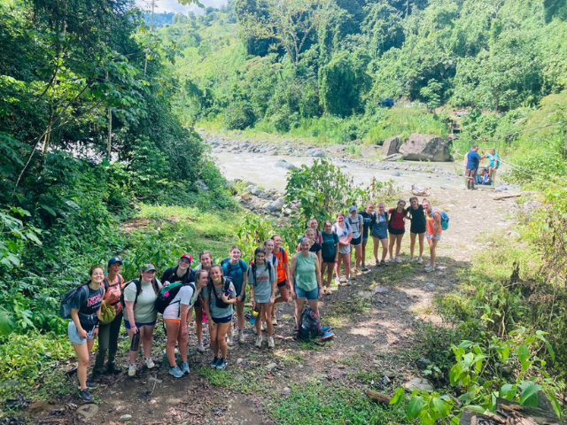 NDA students standing on hike to rainforest