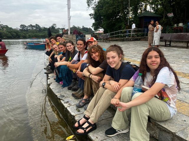students sitting on the side water lake water taxi