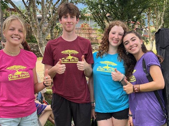 students global routes shirts smiling thumbs up