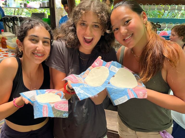 showing off tortilla making skills