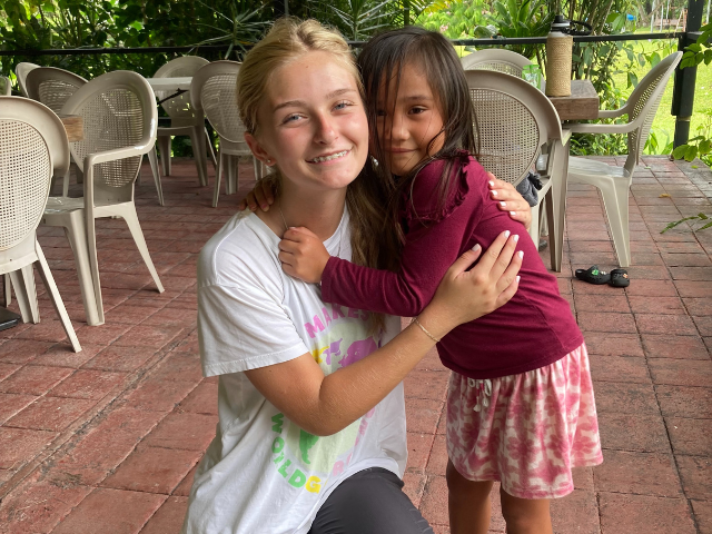 students hugging child