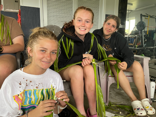 girls weaving together