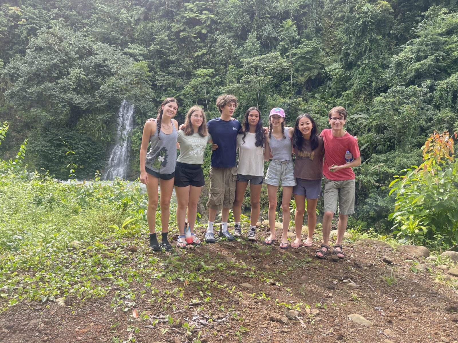 costa rica students in valley holding arms smiling