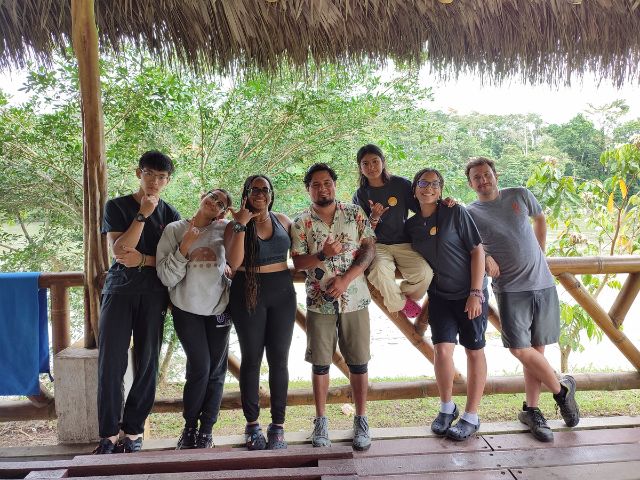 Students posing with rafting guides